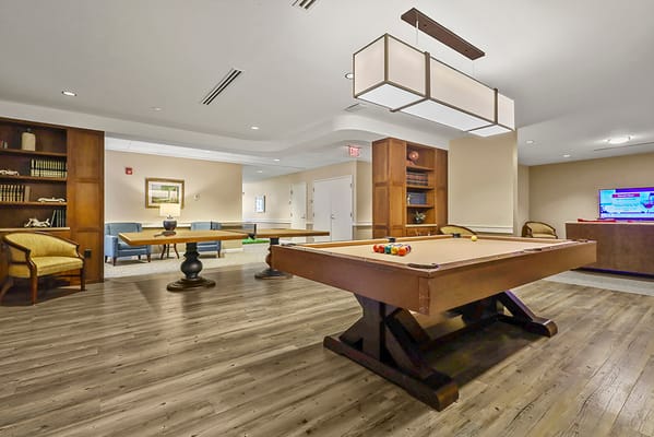Interior common area with billiards table and seating