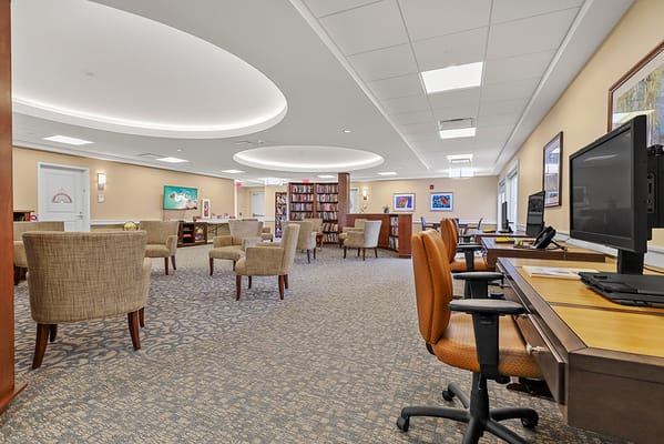 Bright common area with seating and bookshelves