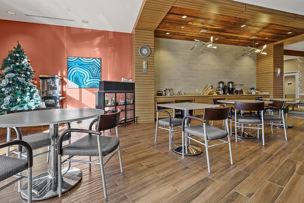 Bright dining area with modern decor and Christmas tree