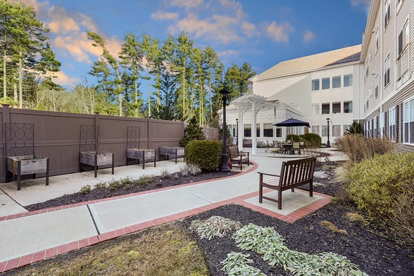 Outdoor garden seating area with benches and landscaping