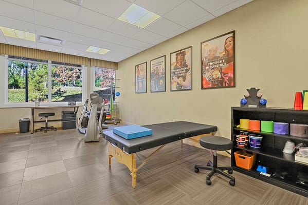 Therapy room with exercise equipment and motivational posters