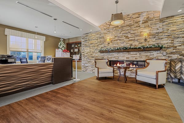 Cozy lobby area with a stone wall and seating