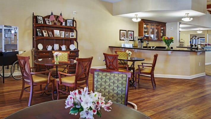 A cozy common area with tables and decor