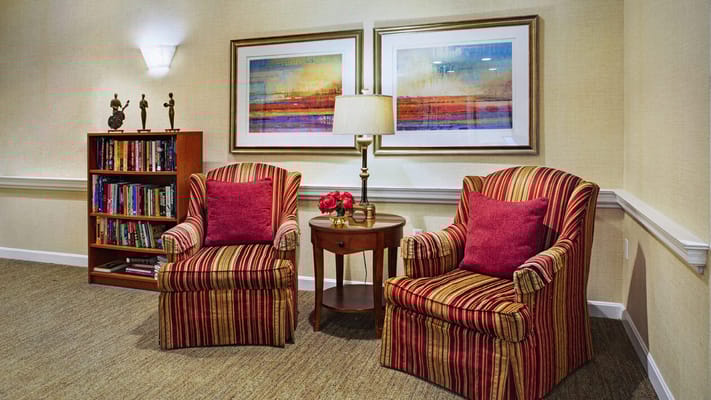 Cozy seating area with bookshelves and artwork