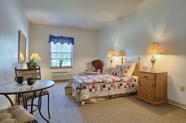 Cozy private resident room with quilted bed