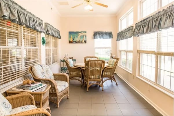 Bright common area with wicker furniture and large windows