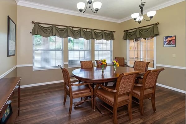 A dining room set up with a large table and chairs