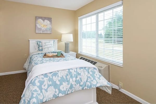 Brightly lit resident bedroom showcasing furniture and decor