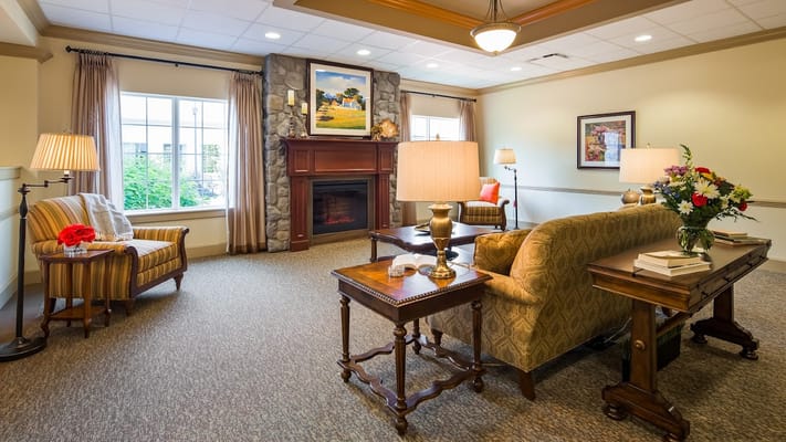 Spacious living room with comfortable seating and a stone fireplace