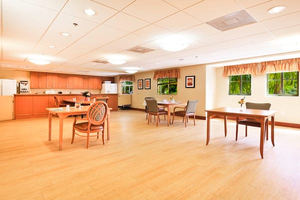 Bright and spacious common area with tables and chairs