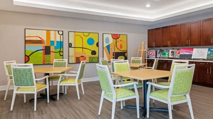 Bright activity room with colorful artwork and seating