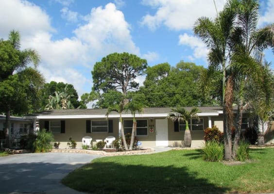 Exterior view of a senior living facility surrounded by greenery