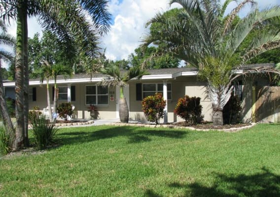 Exterior view of the assisted living facility surrounded by greenery