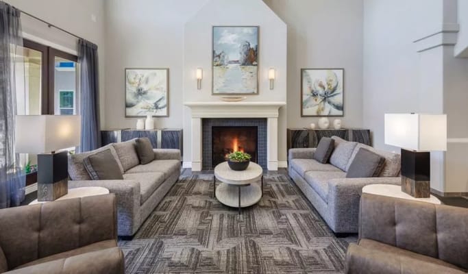 Bright and inviting lobby area with seating and a fireplace