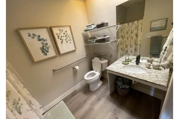 Well-decorated bathroom with floral artwork