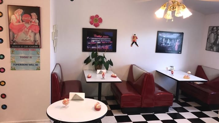 Cozy dining area with red booths and retro decor