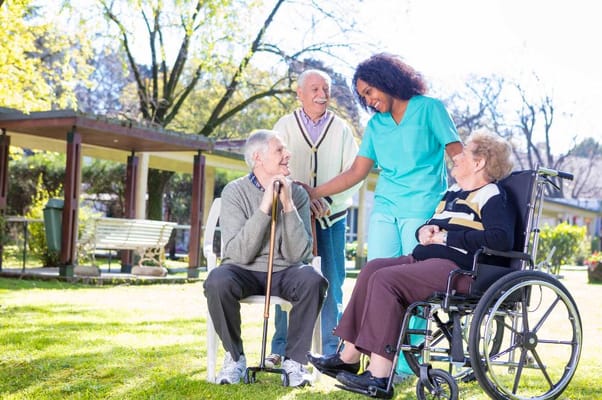 Residents interacting with staff in an outdoor space