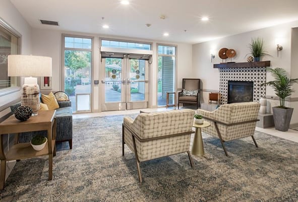 A welcoming lobby with seating and fireplace at Raincross at Riverside.