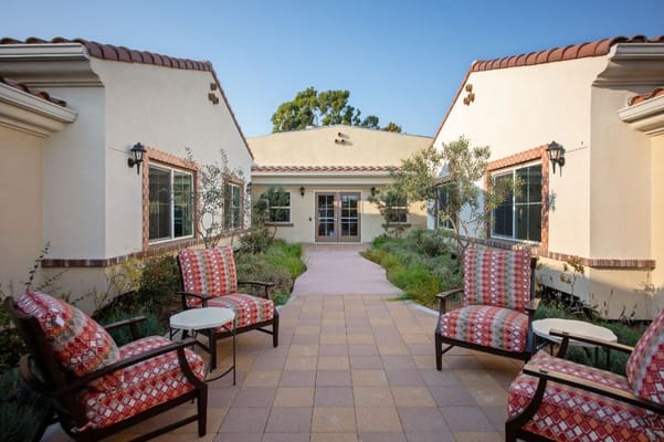Outdoor seating area surrounded by greenery