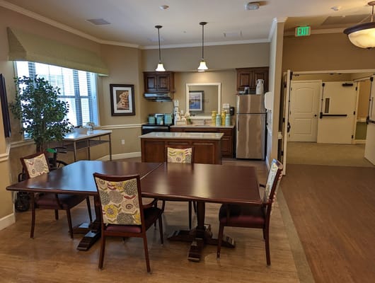 Dining area with a large table and kitchenette