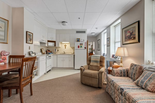 Living room with a kitchen area in a senior apartment