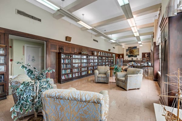 Cozy library lounge with bookshelves and comfortable seating