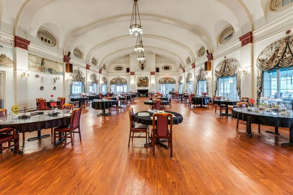 Elegant dining room with round tables and ornate decor