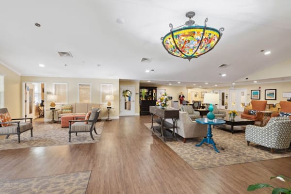 Spacious common area with seating and decorative chandelier