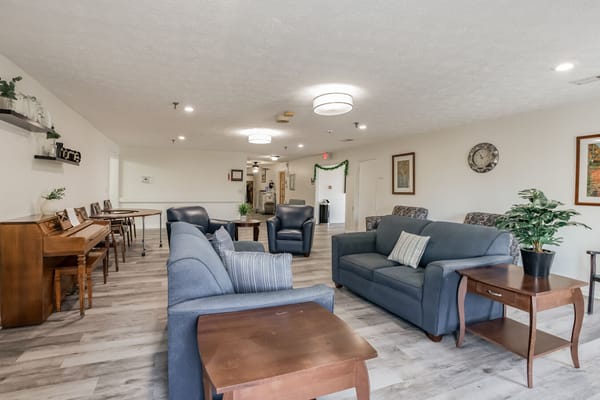 Bright common area with seating and piano
