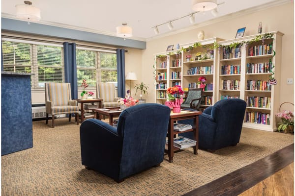 Inviting living room with bookshelves and seating areas