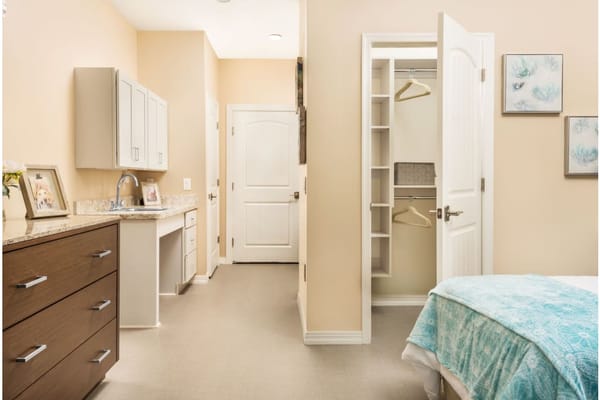 Interior view of a cozy bedroom with a bed, dresser, and closet.