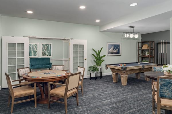 Interior of the game room featuring a poker table and a pool table