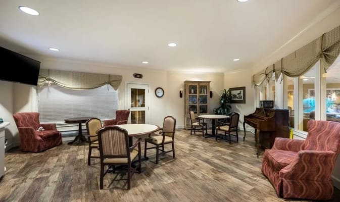 Cozy lounge area with seating and a piano