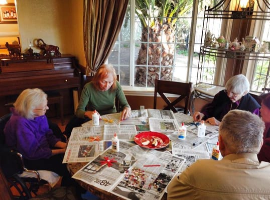 Residents engaging in a craft activity at a table