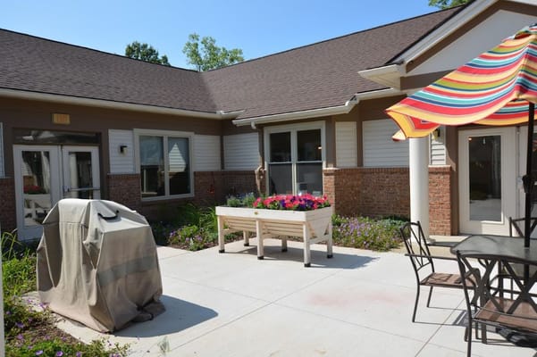 Outdoor seating area with flowers and patio furniture