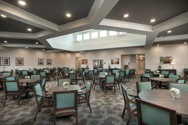 Bright and spacious dining room with tables and chairs
