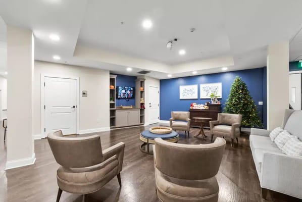 Common area with seating and a Christmas tree
