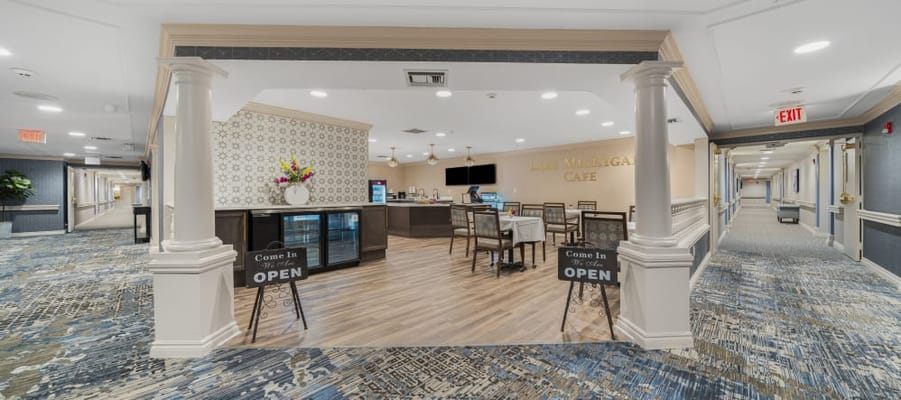 View of the cafe interior featuring seating and a welcome sign.