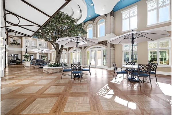 Bright common area with seating and umbrellas