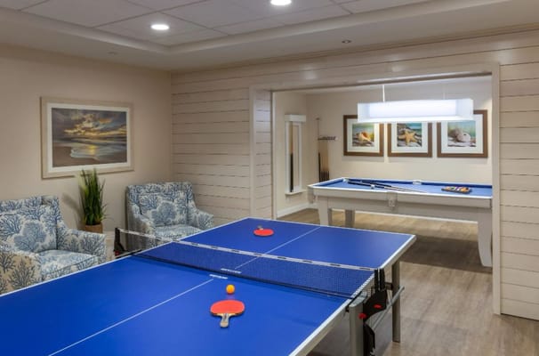 Table tennis area with seating and artwork