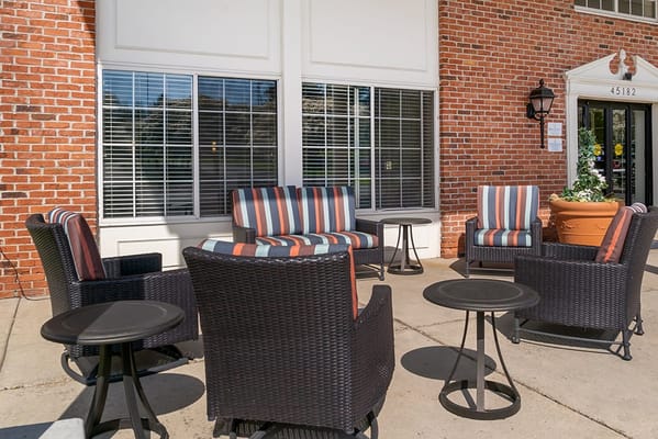 Outdoor seating area with striped chairs and tables