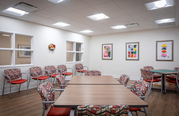 Common area with chairs and tables in The Carrington