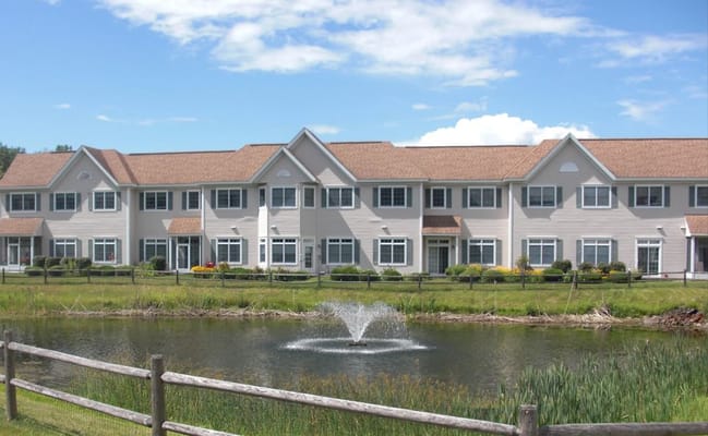Exterior view of Coburg Village residential building by a pond
