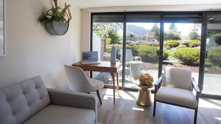 Bright interior with view of outdoor garden and seating area