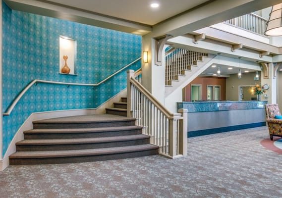 Interior view of a vibrant lobby area with staircase