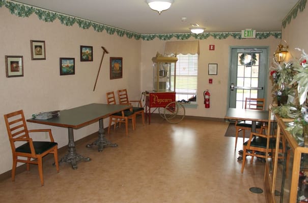 Cozy common area with seating and a popcorn cart