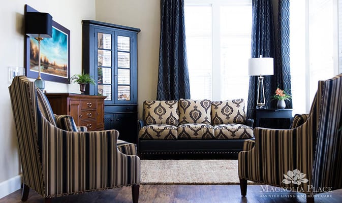 Comfortable living room with patterned sofa and striped chairs