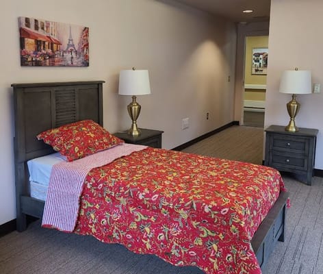 Well-decorated resident room with floral bedding