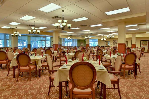 Elegant dining room setup with tables and chairs at The Craig Senior Living