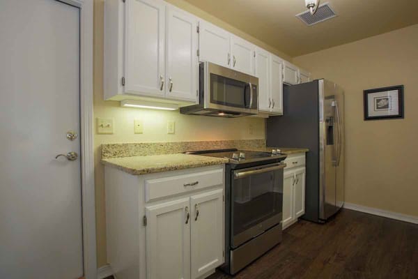 Well-equipped kitchen with stainless steel appliances and granite countertops.